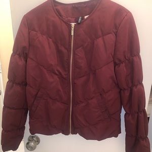 The coat it’s very warm  the color is  Burgundy